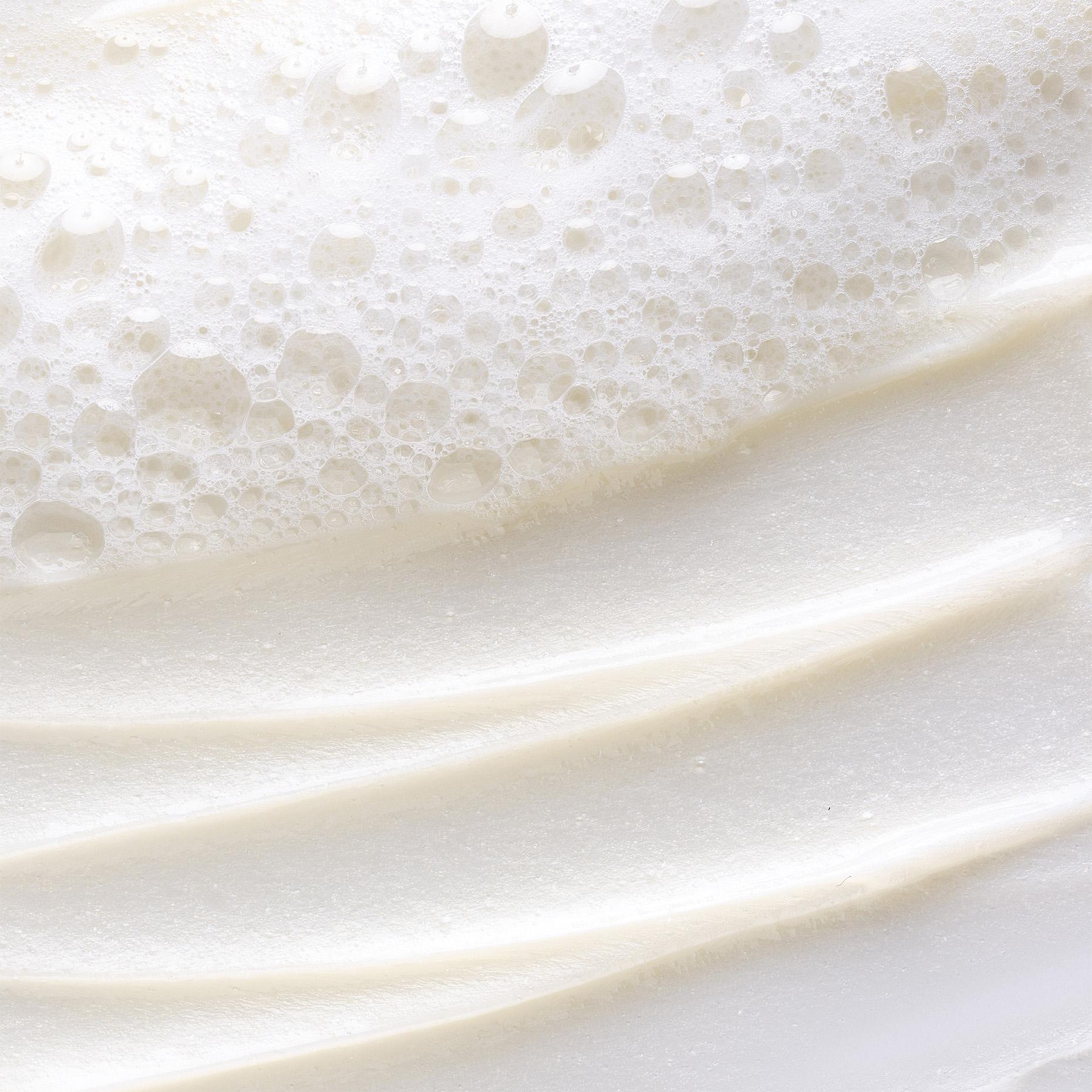 Close-up of white foam with bubbles and creamy swirls.