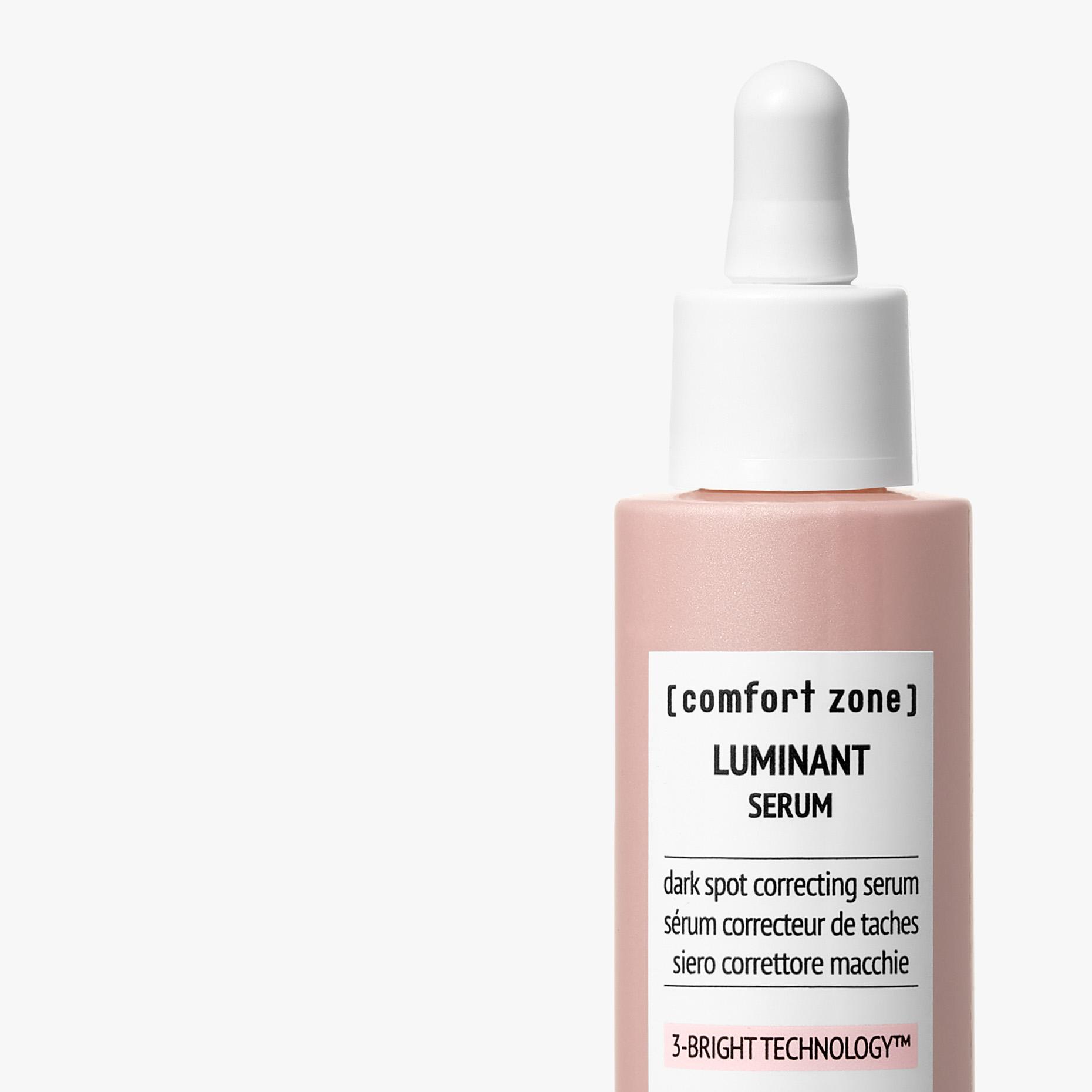 Pink bottle with white dropper top, labeled 'LUMINANT SERUM' and 'dark spot correcting serum'. | [comfort zone] LUMINANT SERUM dark spot correcting serum sérum correcteur de taches siero correttore macchie 3-BRIGHT TECHNOLOGY™ | [comfort zone] LUMINANT SERUM dark spot correcting serum sérum correcteur de taches siero correttore macchie 3-BRIGHT TECHNOLOGY™