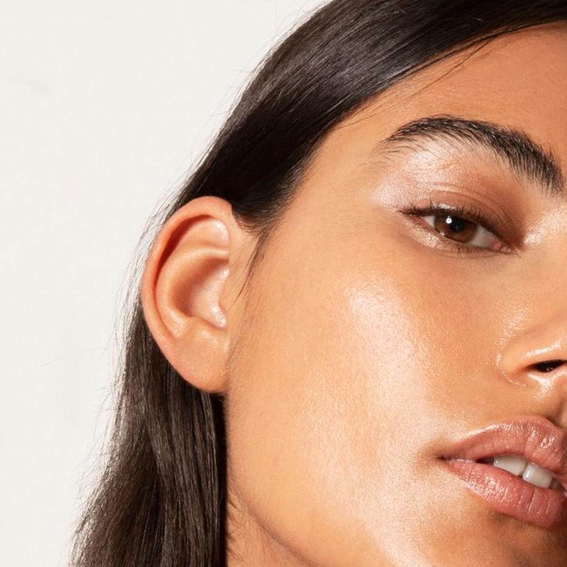 Close-up of a person's face showing their ear, eye, and lips.